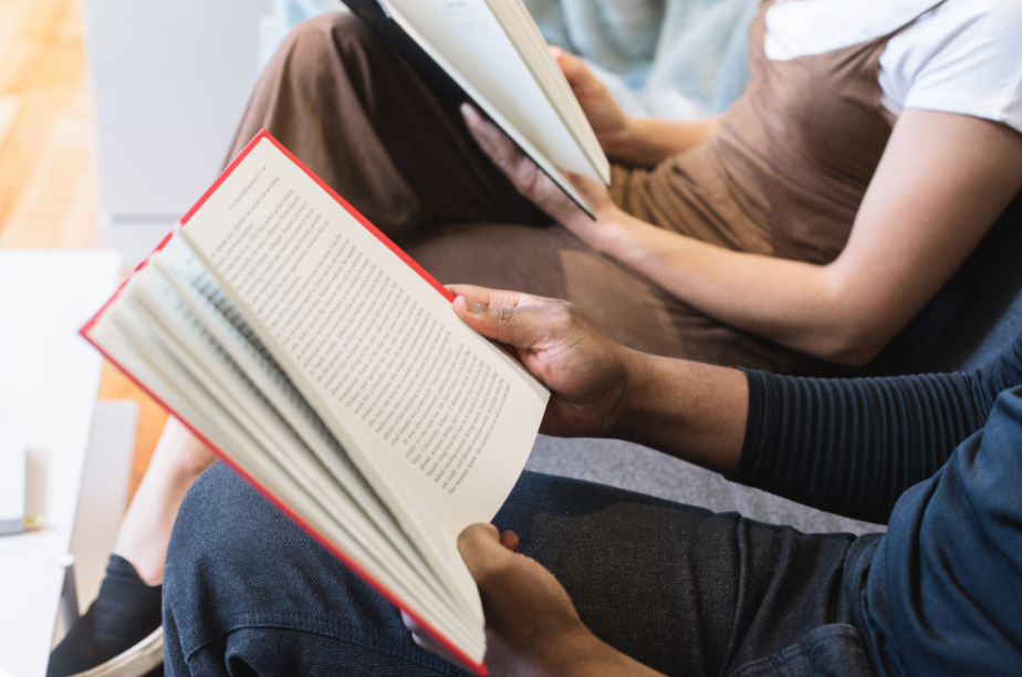 man and woman holding a book